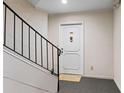 Close-up of a secure entry door with a unique door knocker and carpeted landing at 5400 Roswell Rd # Apt L6, Sandy Springs, GA 30342