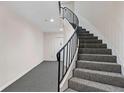 Elegant staircase featuring carpeted steps and a wrought iron railing, leading to the upper levels at 5400 Roswell Rd # Apt L6, Sandy Springs, GA 30342