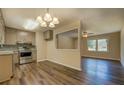Eat-in kitchen featuring stainless steel appliances, granite countertops, and wood-look flooring at 170 Hidden Pines Dr, Covington, GA 30016