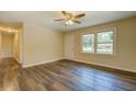 Bright living room with wood-look floors, neutral walls, and a large window offering natural light at 170 Hidden Pines Dr, Covington, GA 30016