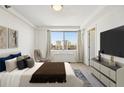 Bedroom featuring a large window with city views and neutral decor at 2479 Peachtree Ne Rd # 1703, Atlanta, GA 30305