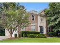 Beautiful brick house with green lawn, a mix of brick and stucco, and a blue front door at 6057 Glencedar Ln, Atlanta, GA 30349
