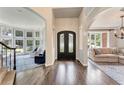 Elegant foyer featuring hardwood floors, arched doorways, and a view into the living area at 6185 Masters Club Dr, Suwanee, GA 30024