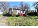Charming home with red accents and a small porch, surrounded by greenery at 692 Moreland Se Ave, Atlanta, GA 30316