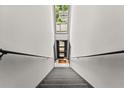 Hallway showcasing stairs leading up to an apartment with railing and a bright skylight at 449 Clairemont Ave # H3, Decatur, GA 30030