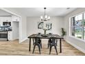 Dining room with modern chandelier, wood-look floors, and large window at 2720 Meridian Ct, Dacula, GA 30019