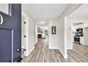Bright entryway with wood-look floors, leading to the living room and kitchen at 2720 Meridian Ct, Dacula, GA 30019