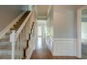 Inviting hallway with hardwood floors, elegant staircase, and classic wainscoting at 2794 Craig Ct, Marietta, GA 30062