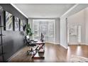 Bright office space featuring a bay window, dark accent wall, and hardwood flooring at 3586 Maple Hill Rd, Stonecrest, GA 30038
