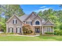 Stunning two-story home with manicured lawn and stone accents, showcasing curb appeal at 407 Amber Ln, Woodstock, GA 30189