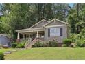Well-kept home featuring a cozy front porch with manicured rose bushes lining the walkway on a sunny day at 532 Lemon Ne St, Marietta, GA 30060