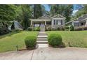 Charming gray home with landscaped front yard and inviting front porch with manicured bushes lining the walkway at 532 Lemon Ne St, Marietta, GA 30060