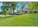 Charming home boasts a beautifully maintained lawn and mature trees at 6918 Heritage Pl, Acworth, GA 30102