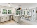 Bright, airy kitchen featuring white cabinets, stainless steel appliances, and a dining area at 100 Spring Ridge Ct, Roswell, GA 30076