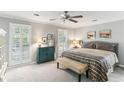 Serene bedroom with shuttered windows, neutral tones and carpeted floor at 100 Spring Ridge Ct, Roswell, GA 30076