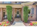 Inviting front porch with stone columns, lush greenery, and a beautifully decorated door, creating a warm welcome at 120 Slate Dr, Buford, GA 30518