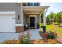 Charming front porch with elegant black front door and nicely landscaped flower beds at 4583 Grenadine Cir, Acworth, GA 30101