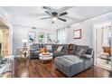 Comfortable living room with recessed lighting, ceiling fan, plush grey sofa and hardwood floors at 46 Le Parc Fontaine, Lithonia, GA 30038