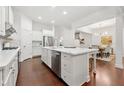 Open kitchen with white cabinets, marble countertops, and stainless steel appliances at 5534 Parkerton Ln, Sandy Springs, GA 30342