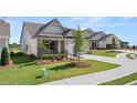 Inviting one-story home with an attached two-car garage and a well-kept lawn in a Gathering-friendly neighborhood at 1629 Tielman Way, Snellville, GA 30078