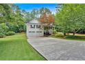 Home with a two-car garage and an inviting front porch with a concrete driveway and beautifully landscaped front yard at 328 West Ln, Woodstock, GA 30188