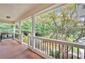 Cozy covered front porch offers a peaceful place to relax and enjoy the view of the landscaped front yard at 328 West Ln, Woodstock, GA 30188