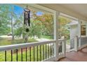 Inviting covered front porch with white columns and black metal railing at 328 West Ln, Woodstock, GA 30188