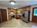 Well-maintained kitchen features stainless steel appliances and wood cabinetry at 328 West Ln, Woodstock, GA 30188