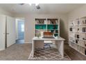 Inviting home office with custom built-in bookshelves, plush carpet, and lots of natural light at 482 Tarragon Sw Way, Atlanta, GA 30331