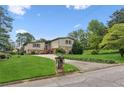 Charming two-story home with a stone facade, well-manicured lawn, and an inviting driveway at 3623 Doroco Dr, Atlanta, GA 30340