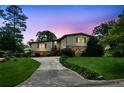 Charming two-story home with a stone facade under a vivid twilight sky and landscaped yard at 3623 Doroco Dr, Atlanta, GA 30340