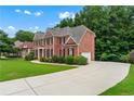 Spacious home featuring an expansive driveway and well-maintained yard at 871 Windsor Creek Dr, Grayson, GA 30017