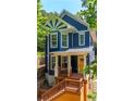 Beautiful blue home showcases a sunburst gable design and welcoming porch entrance at 1454 Rome Nw Dr, Atlanta, GA 30314