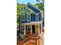 Charming two-story blue home featuring a sunburst gable detail and inviting front porch at 1454 Rome Nw Dr, Atlanta, GA 30314