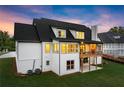 Back of home features large windows, covered porch with fireplace, and a spacious backyard at 6750 Pannell Rd, Buford, GA 30518