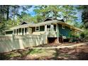 View of side yard featuring a white picket fence and well-maintained landscaping at 1516 Chase Ct, Riverdale, GA 30296