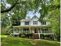Inviting two-story home with a spacious front porch, offering a warm and welcoming curb appeal at 4114 Falcon Shores Nw Ct, Acworth, GA 30101