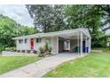 Single-story home with carport, brick facade, well-kept lawn and minimalist landscaping at 1982 Yucca Dr, Decatur, GA 30032