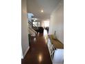 Inviting foyer features hardwood floors, staircase, and decoratively furnished console table at 2311 Arnold Palmer Way, Duluth, GA 30096