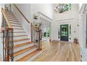 Stunning foyer with a grand staircase, hardwood floors, and elegant chandelier at 2430 Flat Stone Dr, Cumming, GA 30041