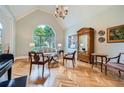 Spacious living room with vaulted ceilings, hardwood floors, and decorative chandelier at 6520 Indian Acres Trl, Tucker, GA 30084