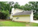 View of the home's rear exterior highlighting the well-kept lawn and exterior color at 9130 Charlton Pl, Douglasville, GA 30135