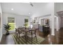 Bright dining room featuring hardwood floors, a modern ceiling fan, and views into the updated kitchen at 2358 Armand Ne Rd, Atlanta, GA 30324