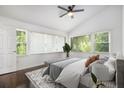 Serene bedroom with large windows, ceiling fan, and a neutral color palette offers relaxing retreat at 2358 Armand Ne Rd, Atlanta, GA 30324