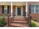 Inviting front door with brick steps, leading up to a covered porch with classic columns at 2667 Hampton Park Dr, Marietta, GA 30062