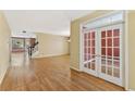 Spacious living room featuring hardwood floors, neutral walls, and elegant french doors at 2667 Hampton Park Dr, Marietta, GA 30062
