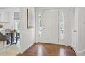 Welcoming entryway featuring hardwood floors, bright natural light, and views to the kitchen at 2800 Mornington Nw Dr, Atlanta, GA 30327