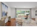 Bright living room with hardwood floors, neutral furniture, and view to the wooded outdoors at 2800 Mornington Nw Dr, Atlanta, GA 30327