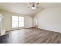 Bright, spacious living room with neutral paint, lots of natural light, and lovely hardwood floors at 4895 Ozment Ridge Ct, Lithonia, GA 30038