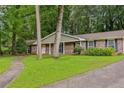 Traditional brick home featuring a lush green lawn and inviting walkway, perfect for families at 763 Brookwood Sw Ter, Lilburn, GA 30047